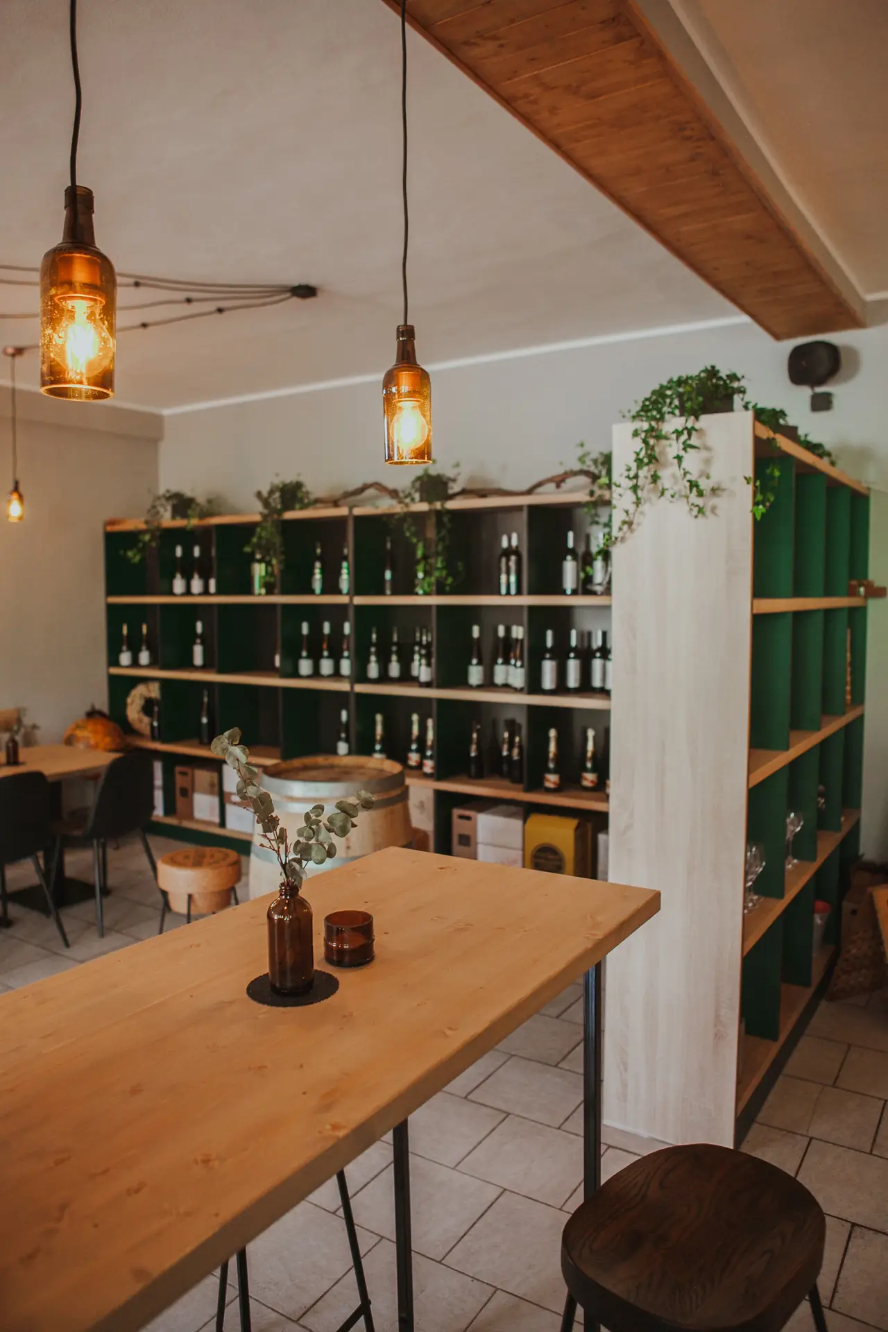 Interior with a green wall and wine shelving